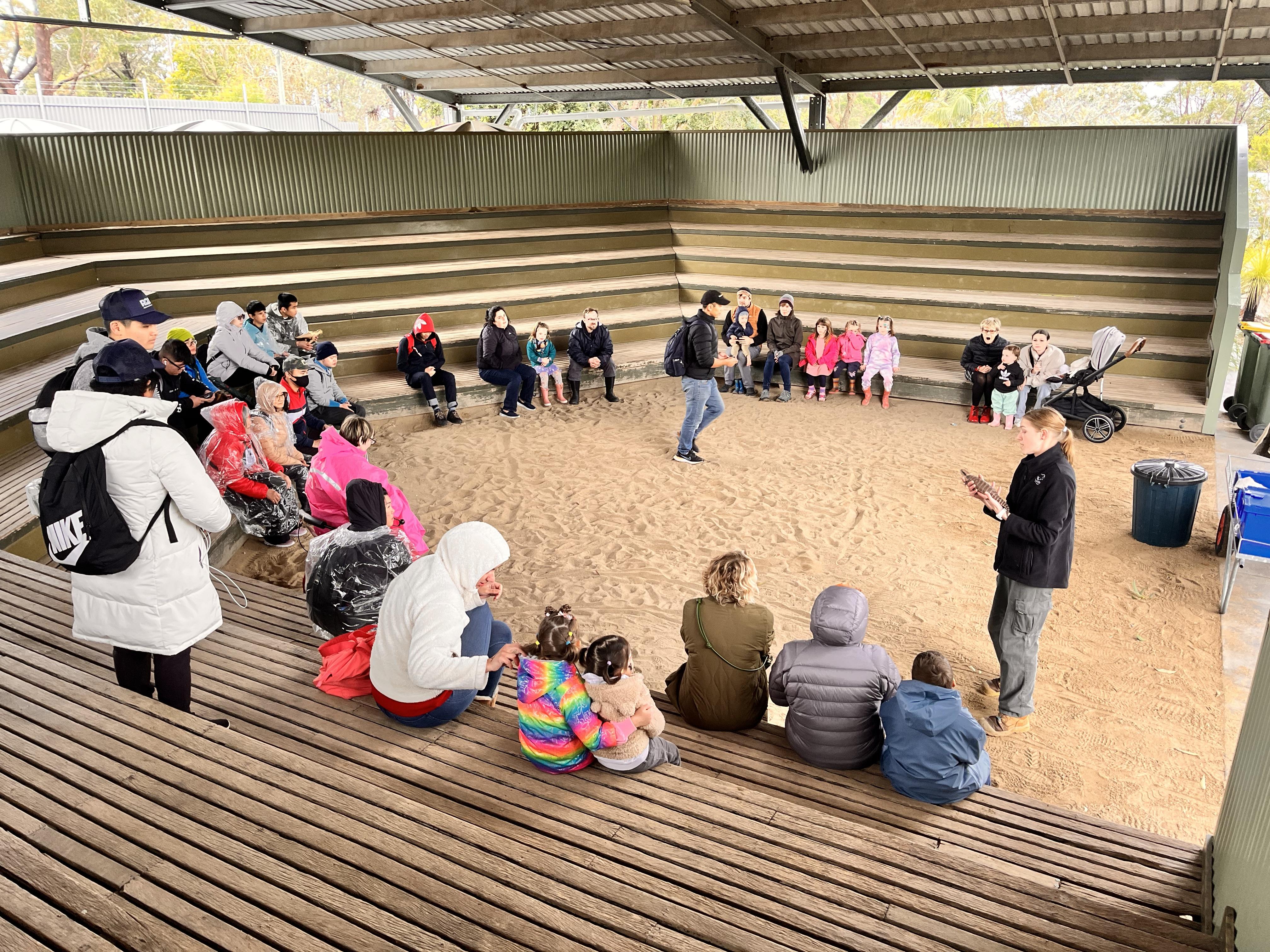 A group of visitors gathered at the Koala Preschool shelter during a bushland wildlife visit