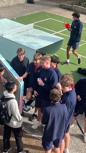 Students playing table tennis together during a campus visit