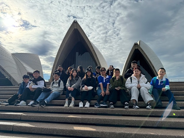 Study tour students sitting on the steps in front of the Sydney Opera House
